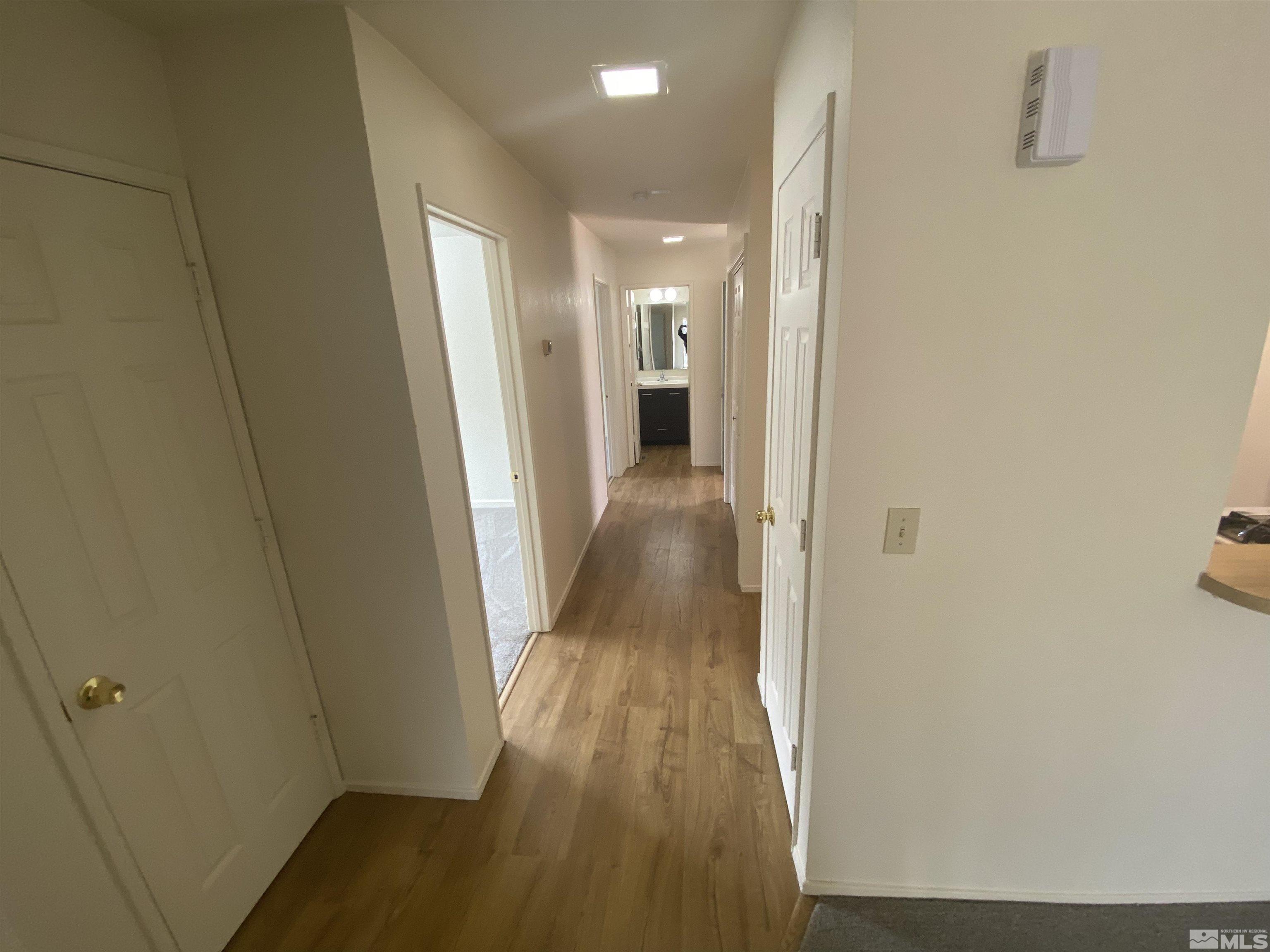 15004 Cuprite Street Reno, NV 89506 - Photo 14 of 22 a view of a hallway with wooden floor