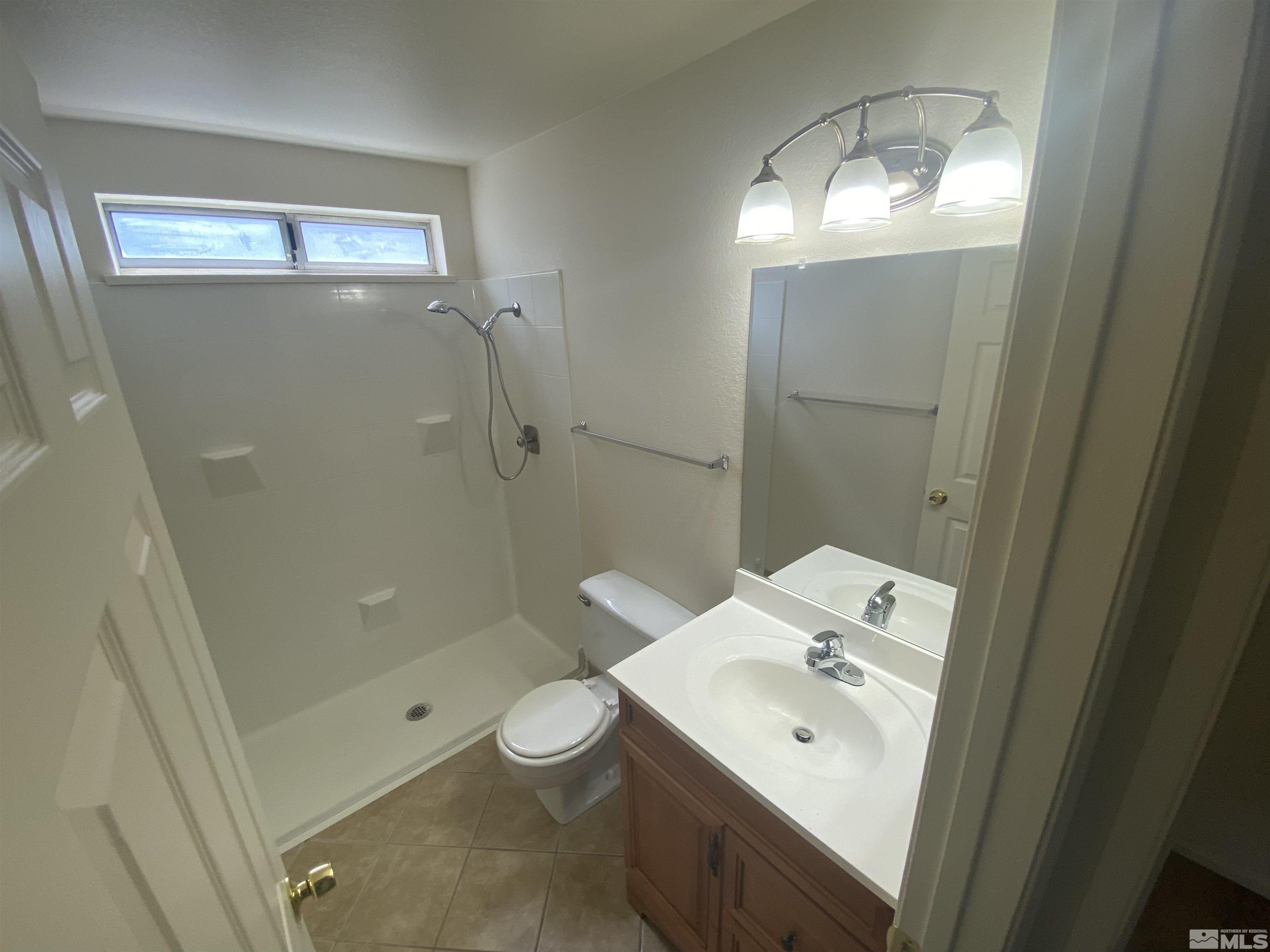 15004 Cuprite Street Reno, NV 89506 - Photo 9 of 22 a bathroom with a sink a toilet and shower