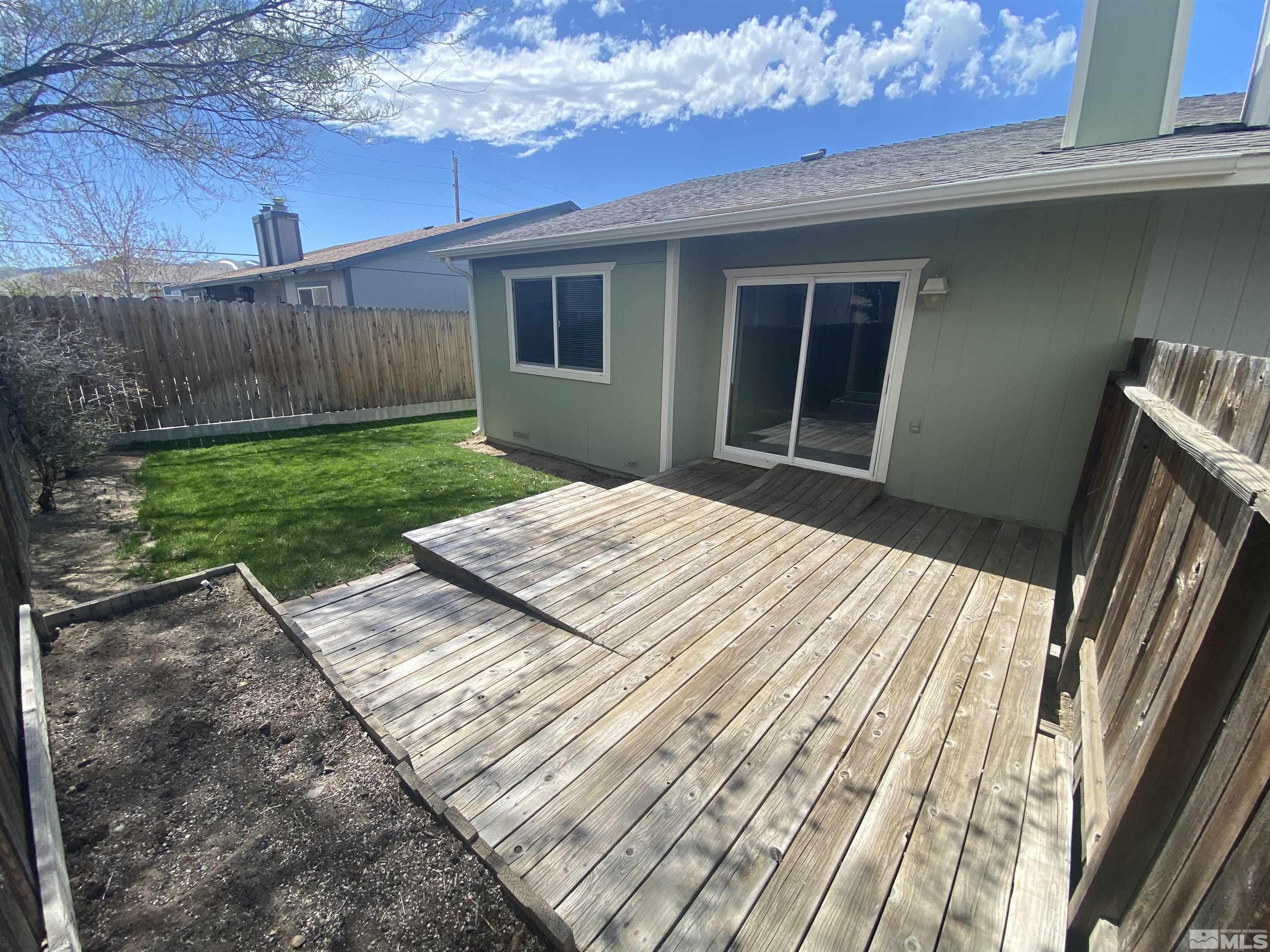 15004 Cuprite Street Reno, NV 89506 - Photo 10 of 22 a view of backyard with wooden fence and large trees