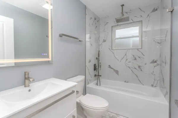 a bathroom with a sink toilet and shower