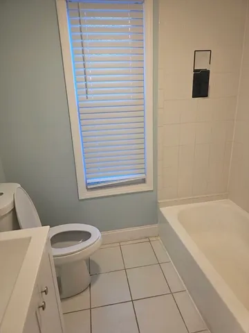 a bathroom with a bathtub and toilet