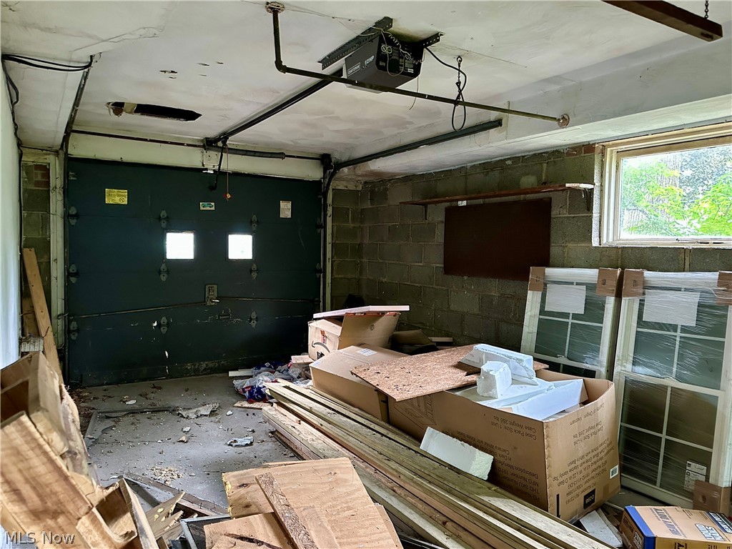 5319 Fairtree Road Bedford Heights, OH 44146 - Photo 18 of 27 Garage interior with a dark green overhead door featuring square window inserts