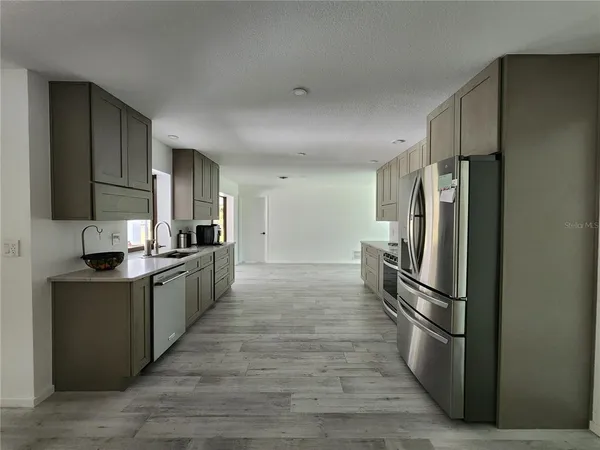 a kitchen with stainless steel appliances a refrigerator and a sink