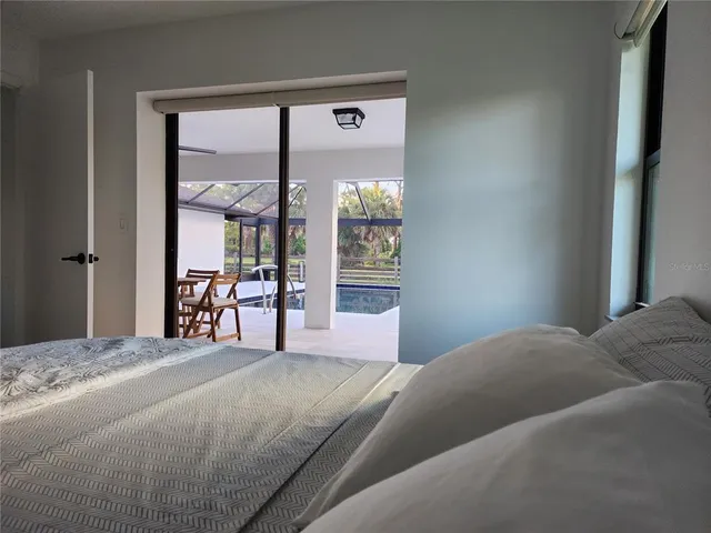 a bedroom with a large bed and a large window