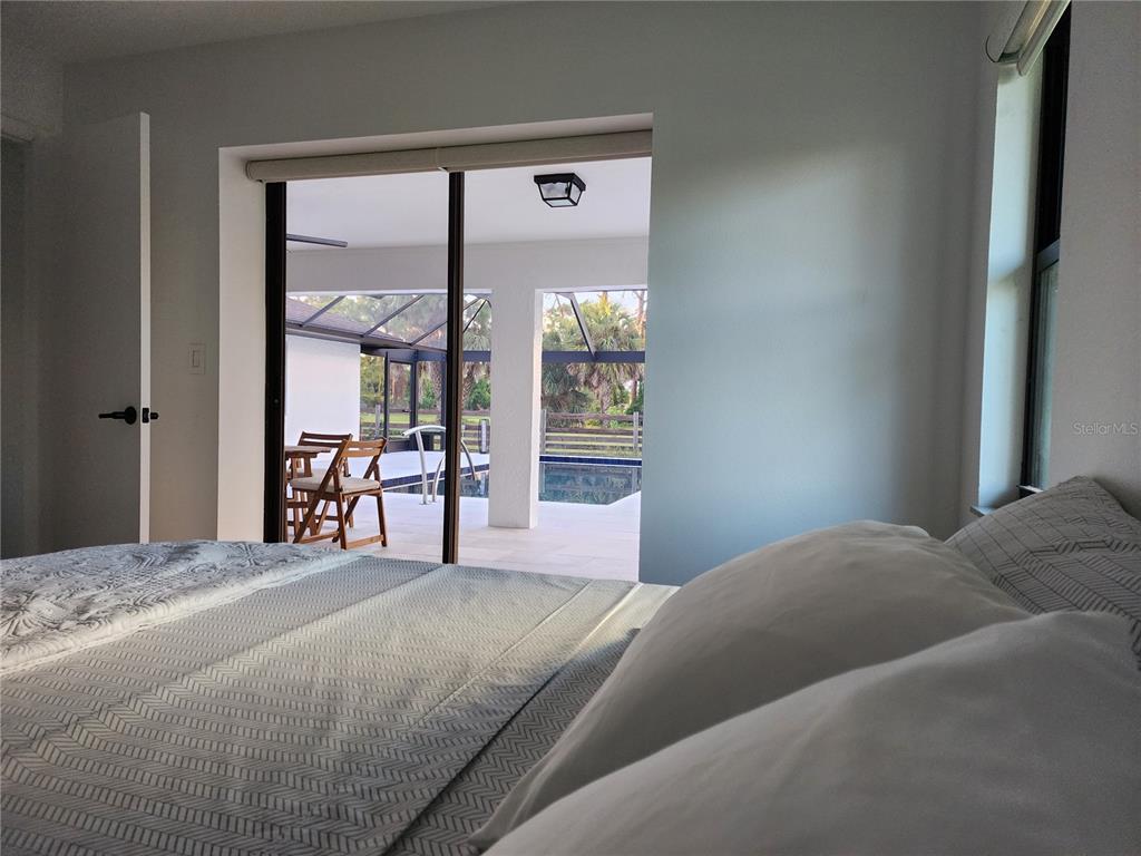 900 Crestwood Road Englewood, FL 34223 - Photo 22 of 38 a bedroom with a large bed and a large window