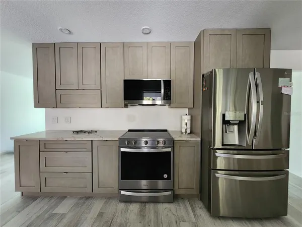a kitchen with a refrigerator stove and microwave