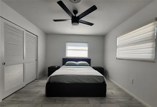 a bedroom with a bed and a window