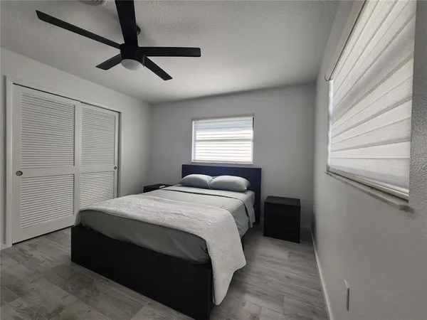 a bedroom with a bed and a window