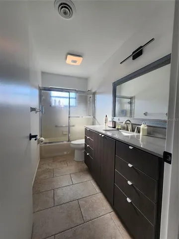 a large kitchen with stainless steel appliances granite countertop a sink and cabinets