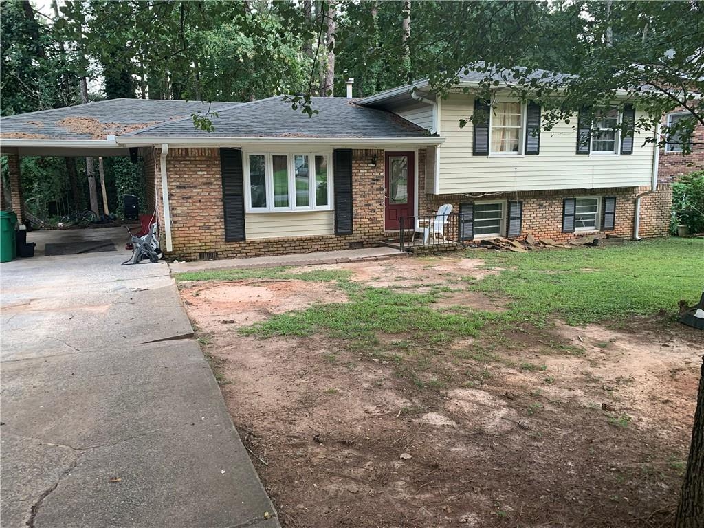3616 Santa Fe Trail Doraville, GA 30340 - Photo 1 of 1 a front view of a house with a garden and porch