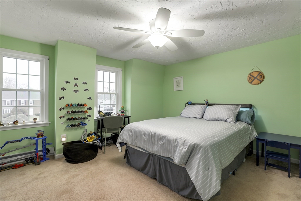585 Turnpike Street, Unit 2 Easton, MA 02375 - Photo 17 of 25 a bedroom with a bed and a chandelier