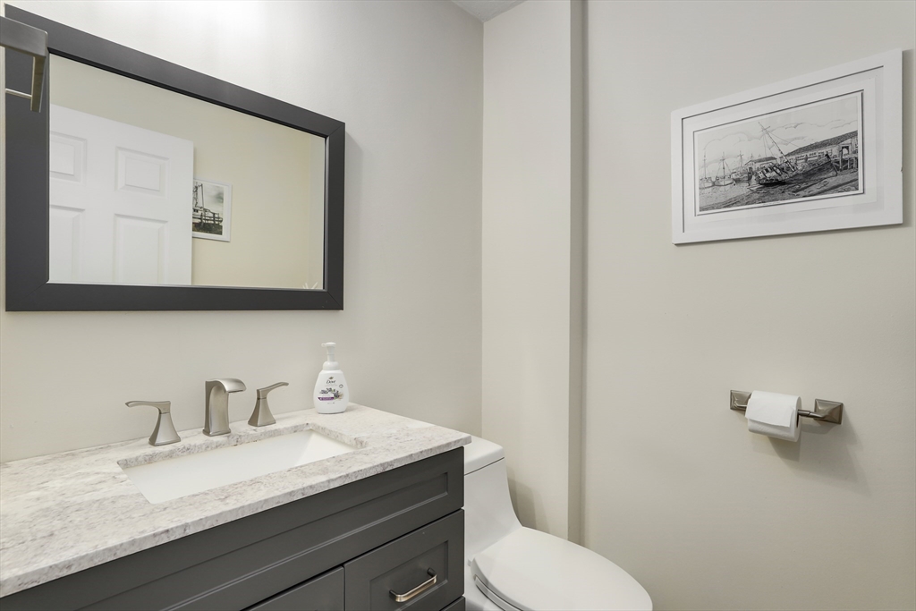585 Turnpike Street, Unit 2 Easton, MA 02375 - Photo 20 of 25 a bathroom with a granite countertop toilet sink and mirror