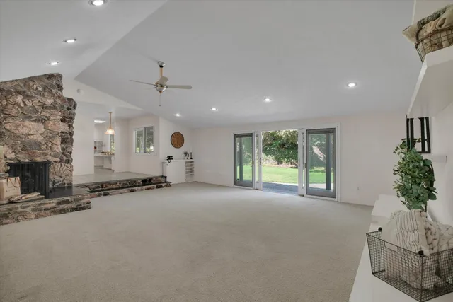 a big room with windows and a fireplace