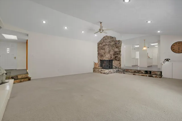 an empty room with a stove and a chandelier