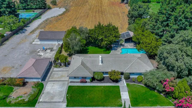 a aerial view of a house with a yard and potted plants