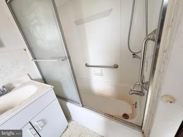 a bathroom with a tub and a shower