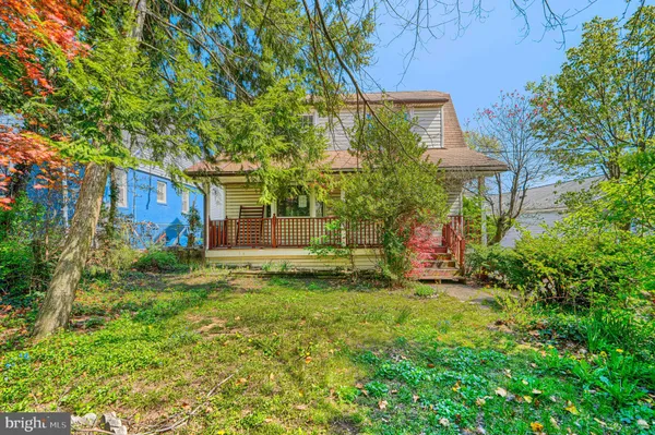 a view of a house with a yard and a tree