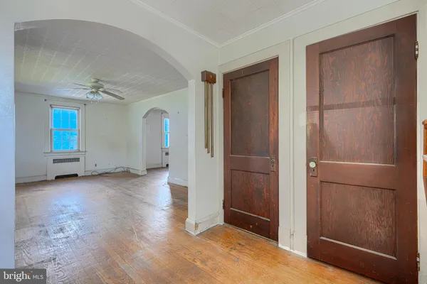 an empty room with windows and entrance