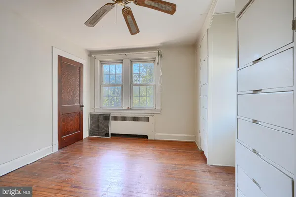 a view of room with window and wooden floor