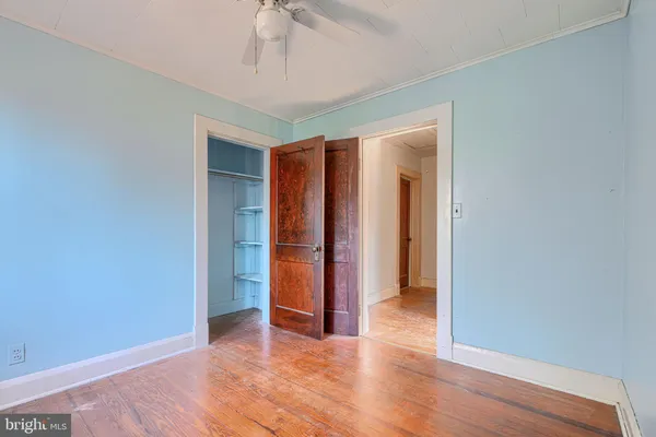 a view of an empty room with wooden floor