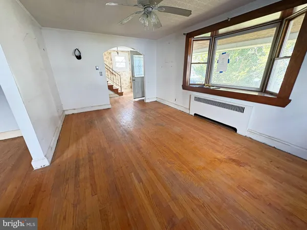wooden floor in an empty room with a window