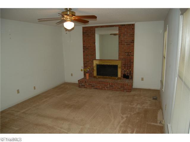 7600 Wallingford Road Greensboro, NC 27409 - Photo 10 of 14 Living Room. The spacious living room features a nice masonry fireplace