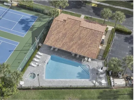 an aerial view of a house with a yard and lake view