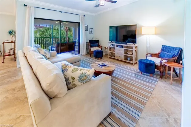 a living room with furniture flat screen tv and a large window
