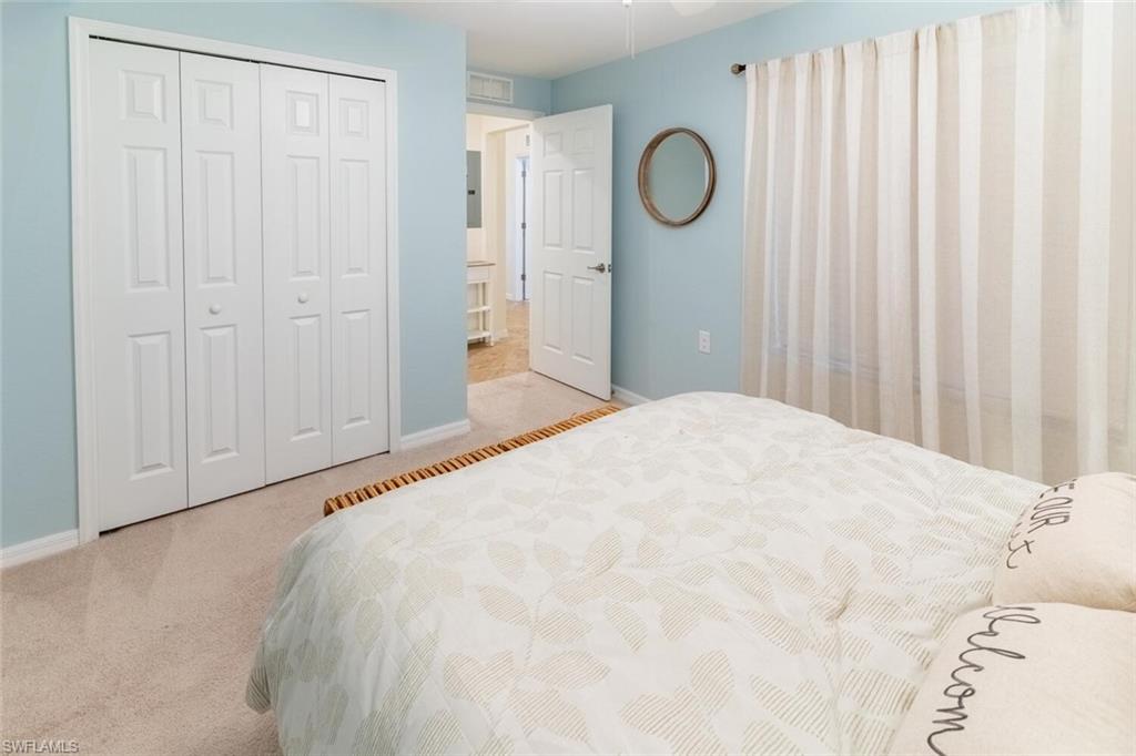 9828 Venezia Circle, Unit 1124 Naples, FL 34113 - Photo 24 of 50 a large white bed in a white room