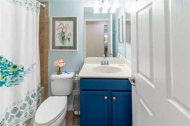 a bathroom with a sink vanity mirror and toilet