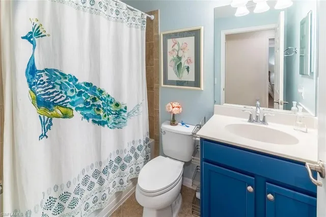 a bathroom with a sink toilet and mirror
