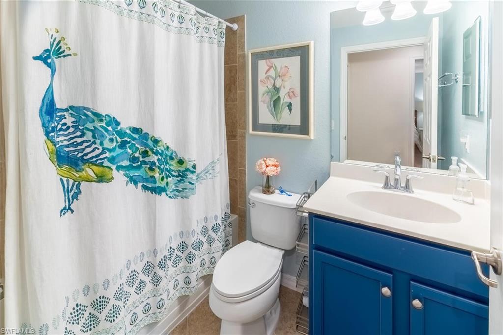 9828 Venezia Circle, Unit 1124 Naples, FL 34113 - Photo 26 of 50 a bathroom with a sink toilet and mirror