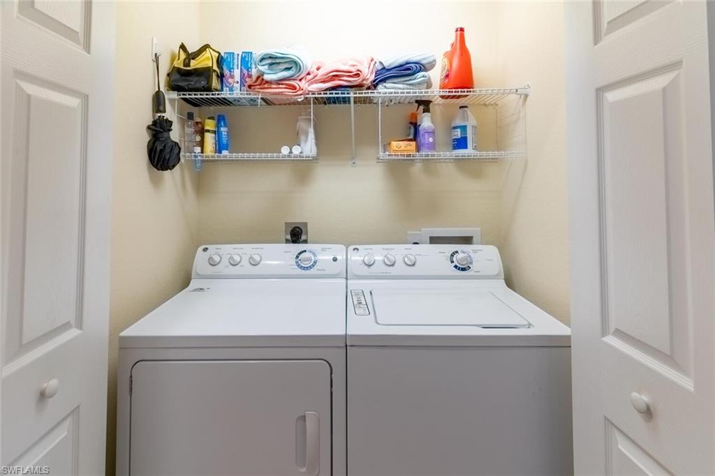 9828 Venezia Circle, Unit 1124 Naples, FL 34113 - Photo 27 of 50 a utility room with dryer and washer