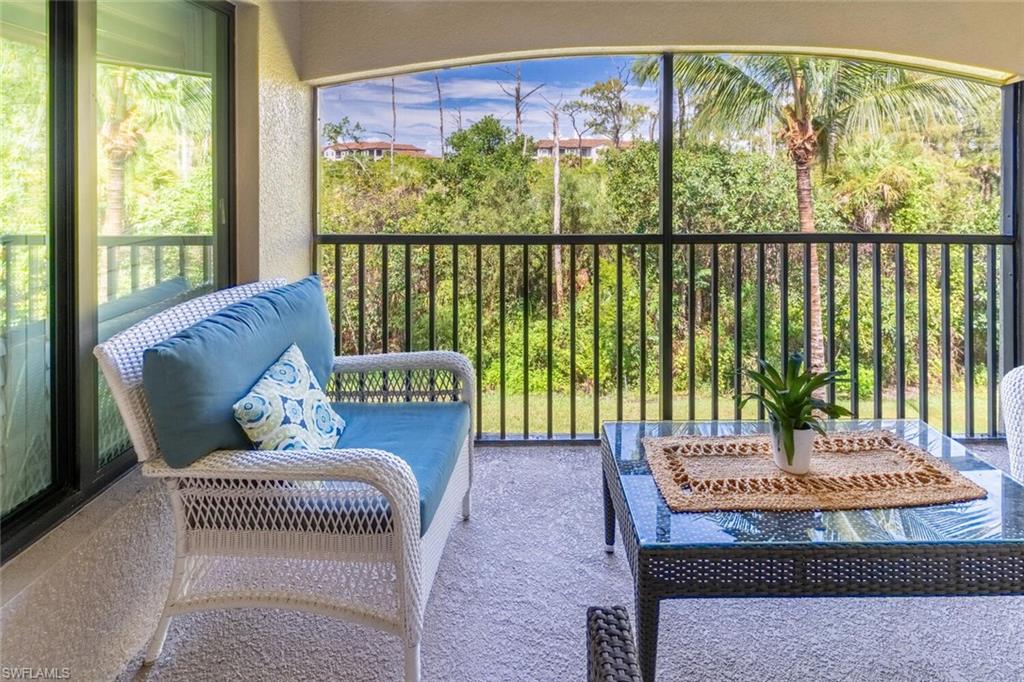 9828 Venezia Circle, Unit 1124 Naples, FL 34113 - Photo 28 of 50 a bench sitting in front of a building