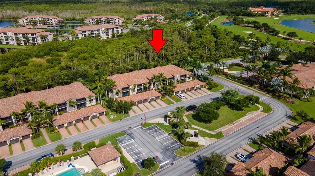 9828 Venezia Circle, Unit 1124 Naples, FL 34113 - Photo 29 of 50 an aerial view of a house with a yard and lake view