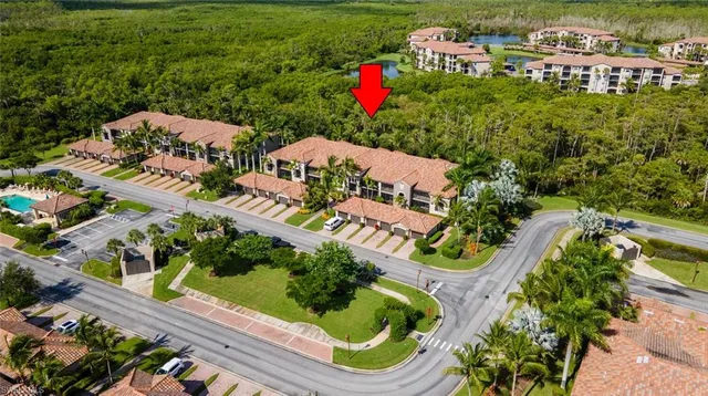 an aerial view of a house with a garden and lake view
