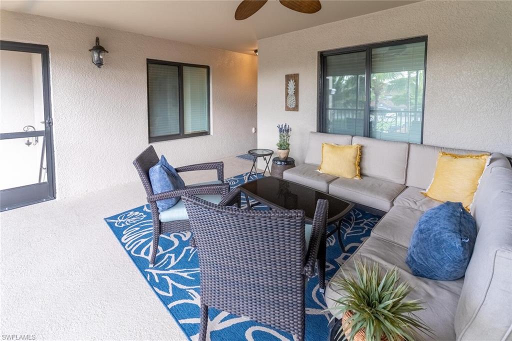 9828 Venezia Circle, Unit 1124 Naples, FL 34113 - Photo 5 of 50 a living room with furniture rug and wooden floor