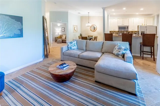 a living room with furniture kitchen and a view of kitchen