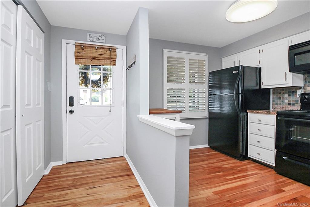 1231 Scaleybark Road, Unit C Charlotte, NC 28209 - Photo 11 of 36 a kitchen with stainless steel appliances granite countertop a refrigerator and a stove top oven