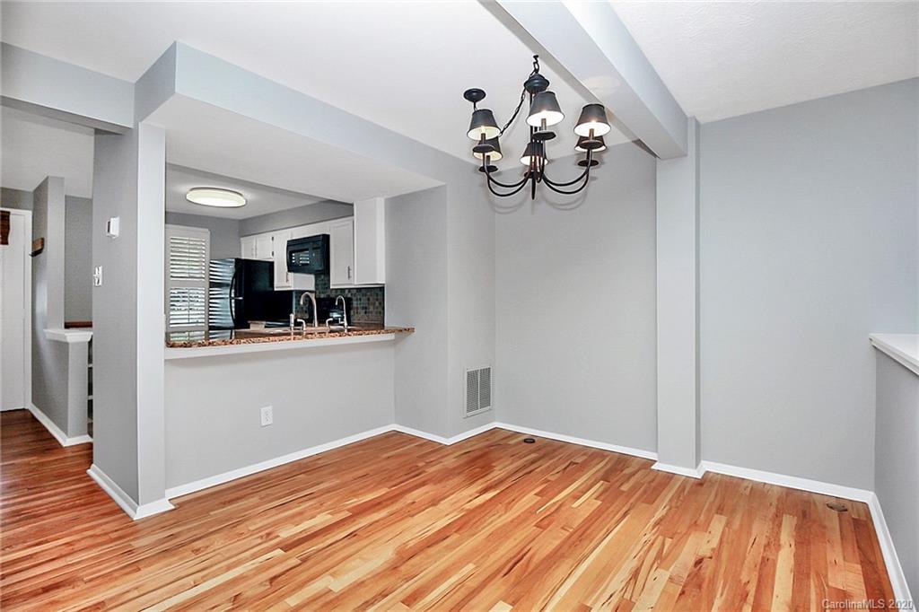 1231 Scaleybark Road, Unit C Charlotte, NC 28209 - Photo 13 of 36 a view of a room with wooden floor and ceiling fan