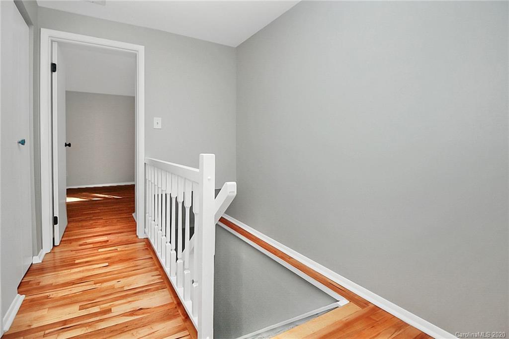 1231 Scaleybark Road, Unit C Charlotte, NC 28209 - Photo 16 of 36 a view of a hallway with wooden floor and stairs