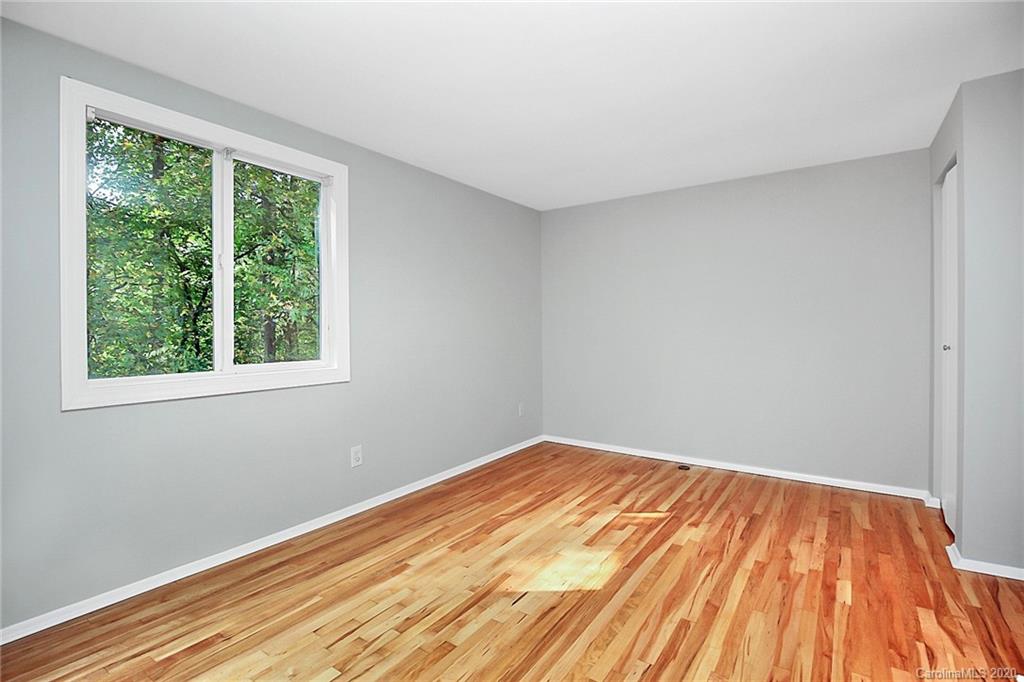 1231 Scaleybark Road, Unit C Charlotte, NC 28209 - Photo 18 of 36 a view of empty room with wooden floor and fan
