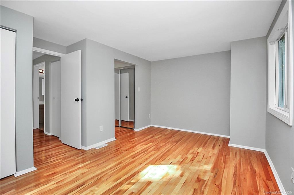 1231 Scaleybark Road, Unit C Charlotte, NC 28209 - Photo 19 of 36 a bedroom with a bed and wooden floor