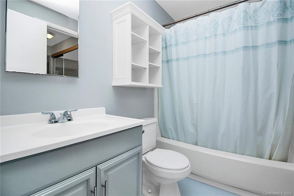 1231 Scaleybark Road, Unit C Charlotte, NC 28209 - Photo 23 of 36 a bathroom with a sink and a mirror