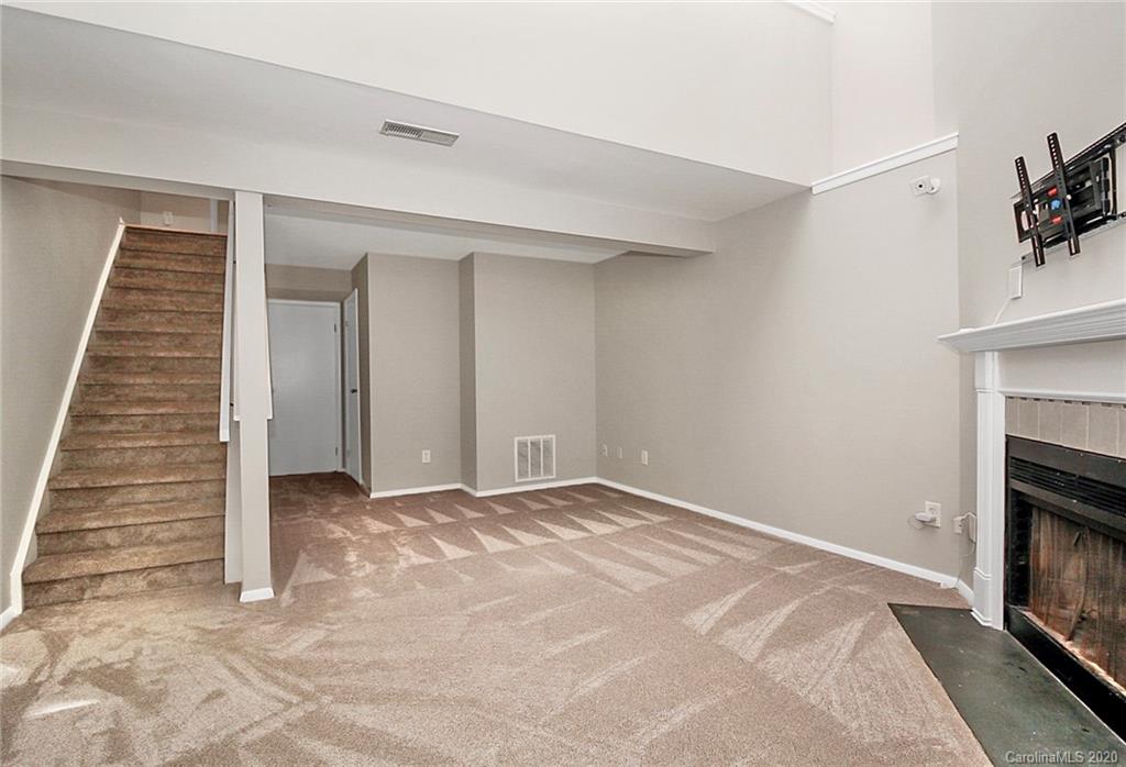 1231 Scaleybark Road, Unit C Charlotte, NC 28209 - Photo 29 of 36 a view of an empty room with a fireplace and a window
