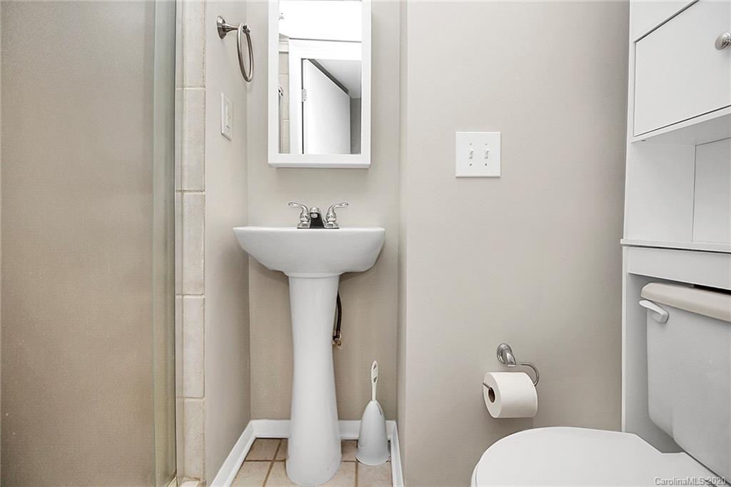 1231 Scaleybark Road, Unit C Charlotte, NC 28209 - Photo 32 of 36 a bathroom with a toilet sink and mirror