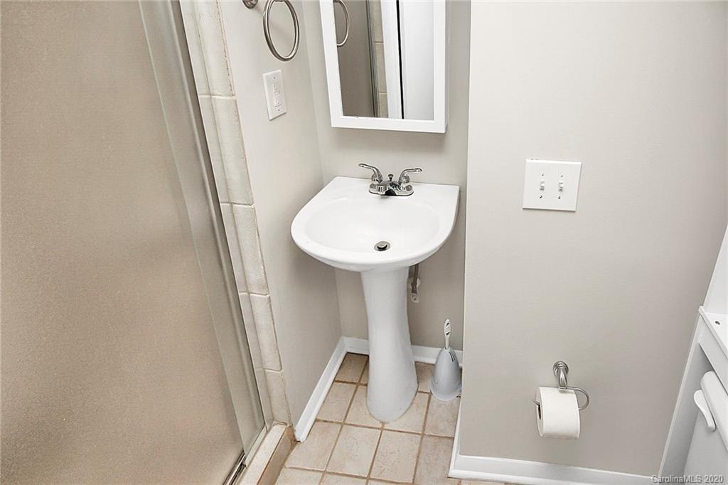 1231 Scaleybark Road, Unit C Charlotte, NC 28209 - Photo 33 of 36 a bathroom with a sink and a mirror