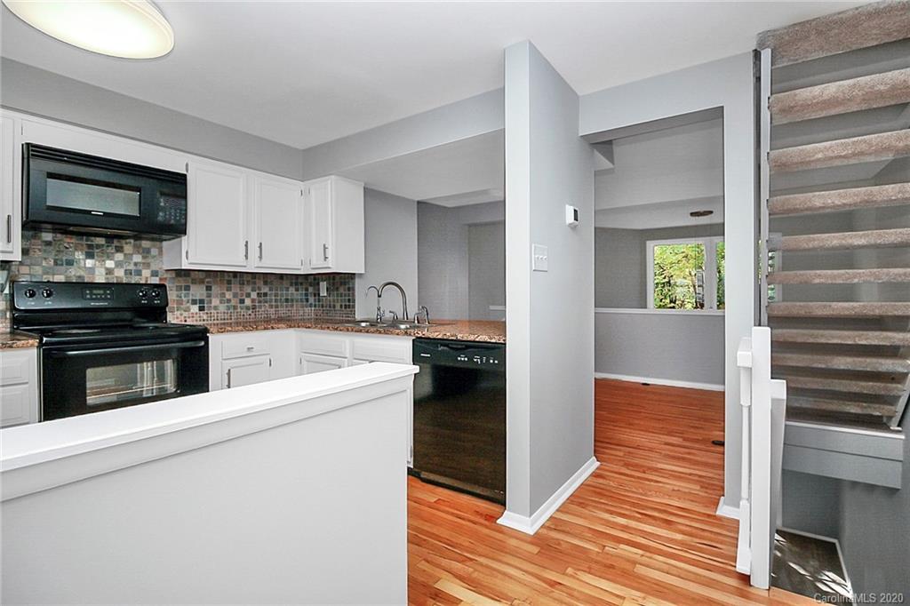 1231 Scaleybark Road, Unit C Charlotte, NC 28209 - Photo 6 of 36 a kitchen with a refrigerator and a stove top oven