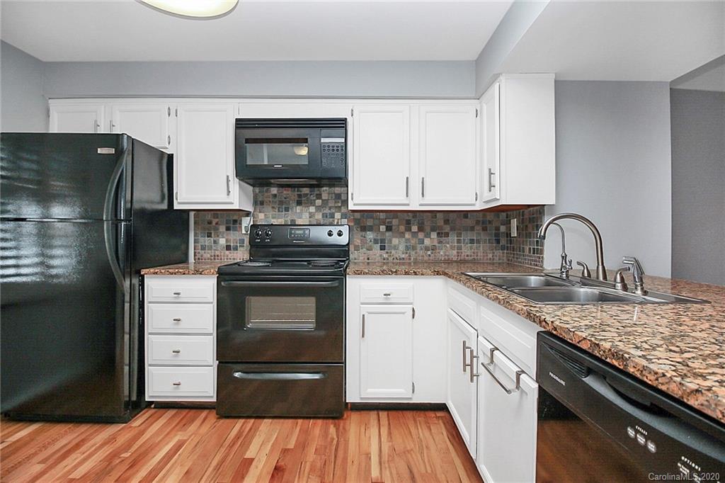 1231 Scaleybark Road, Unit C Charlotte, NC 28209 - Photo 7 of 36 a kitchen with stainless steel appliances granite countertop a stove and a refrigerator