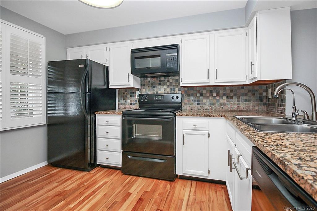 1231 Scaleybark Road, Unit C Charlotte, NC 28209 - Photo 8 of 36 a kitchen with granite countertop a refrigerator stove and sink